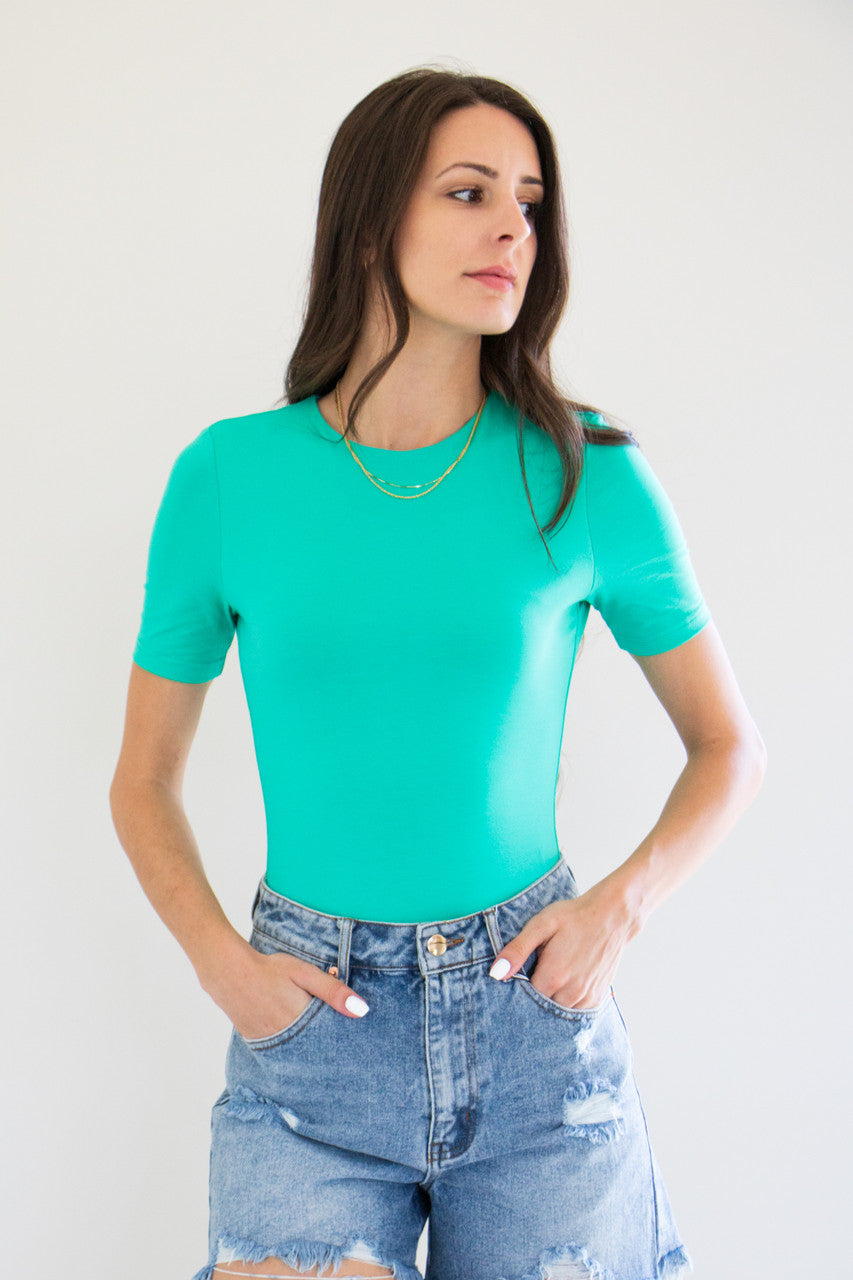 An essential bodysuit with a close fit and lightweight fabric, Pavani features a solid and smooth finish with a crew cut neckline, tee sleeve and just a little bit of stretch.

