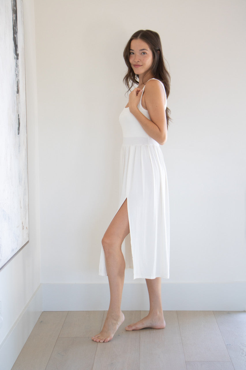 Our best selling summer dress is back in five seasonal colours. Made with a flattering silhouette and scooped neckline, the perfect amount of stretch and a side split to mid thigh. Viscose based fabric has a soft, flowing quality - easy to wear casually and effortless to elevate for something more formal. 
